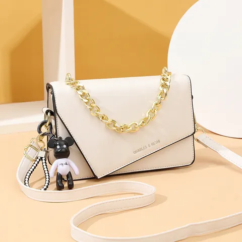 Women Shoulder Bag PU Leather Asymmetric Flap Geometric Small Square Crossbody Bag With Chunky Gold Chain And Bear Pendant
