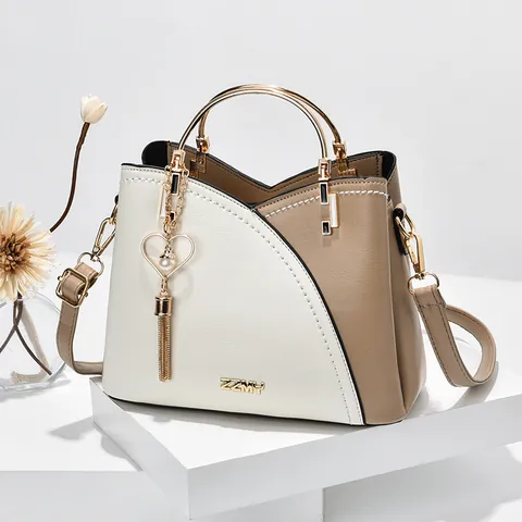 Damen Farbblock PU Leder Handtasche Mit Rundem Metallgriff Herz Quaste Anhänger Umhängetasche Für Den Täglichen Gebrauch