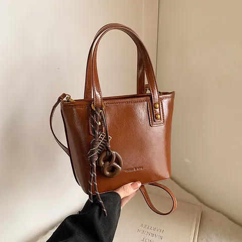 Women Vintage Oil Wax PU Leather Bucket Bag Simple Casual Tote Handbag With Adjustable Shoulder Strap And Decorative Charm Fashion Bag