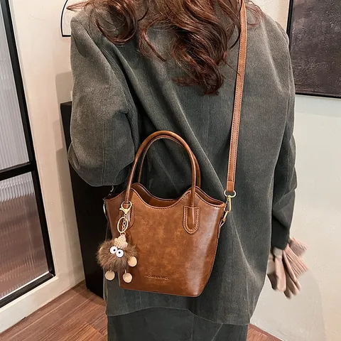 Women Vintage PU Leather Bucket Bag Minimalist Solid Color Wavy Edge Shoulder Crossbody Handbag With Plush Charm For Daily Use