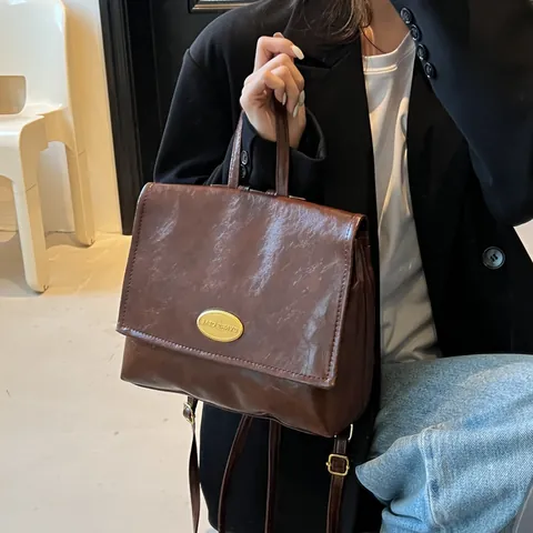 Vintage Korean Style PU Leather Backpack For Women Large Capacity Waterproof Commuting Handheld Bag With Gold Metal Plate