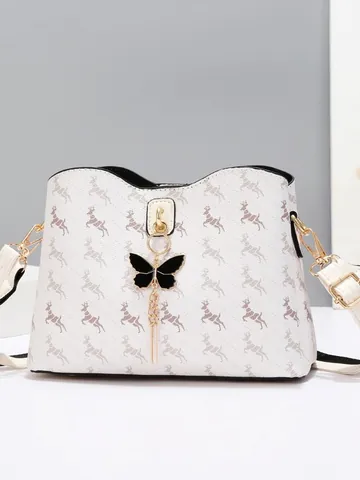 Women Faux Leather Bucket Bag Repeating Animal Print Butterfly Pendant Gold Tassel Metal Hardware Wide Chevron Strap Crossbody Shoulder Bag