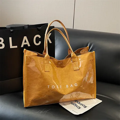 Minimalistische Damen Große Kapazität PVC DuPont Papier Einkaufstasche Buchstaben Druck Wasserdicht Transparent Jelly Schultertasche