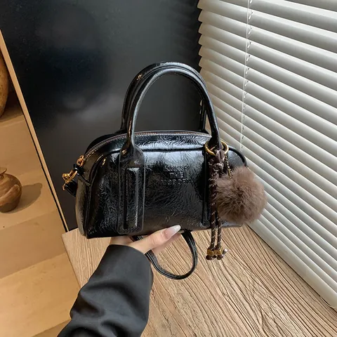 Women Retro PU Leather Boston Bag Shiny Wrinkled Bowling Handbag With Pom Pom Pendant Letter Embossed Shoulder Crossbody Bag