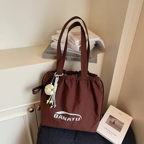 Women Casual Nylon Drawstring Tote Bag BANATU Letter Print Large Capacity Shoulder Bag With Plush Pendant Daily Handbag