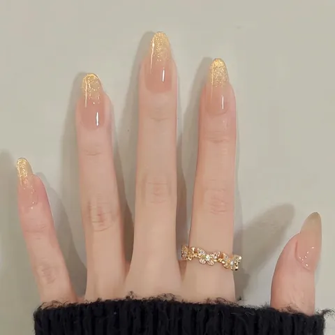 Unghie Finte a Pressione Francesi con Sfumatura Glitter Oro Lusso Champagne Scintillante Rosa Nudo Forma a Mandorla per Donna