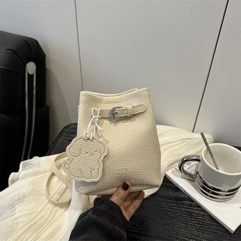 Women Urban Minimalist PU Litchi Texture Bucket Bag Versatile Crossbody Shoulder Bag With Metal Buckle And Cartoon Dog Pendant