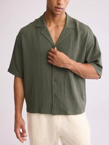 Men Short Sleeve Casual Shirt Textured Fabric Solid Color Loose Fit Lapel Button Down Resort Style Summer Top For Men