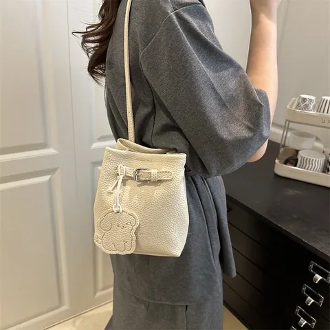 Women Urban Minimalist PU Litchi Texture Bucket Bag Versatile Crossbody Shoulder Bag With Metal Buckle And Cartoon Dog Pendant
