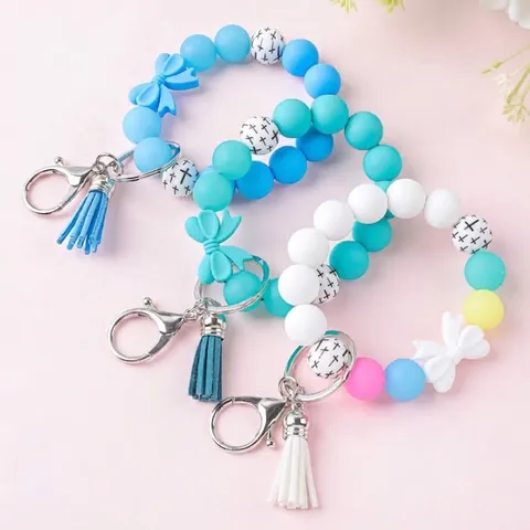 Siliconen Kralen Sleutelhanger Polsband Met Strik En PU Kwast Lichtgevende Kralen Sleutelhanger Armband Voor Vrouwen Kruispatroon Sleutelring Tas Accessoires