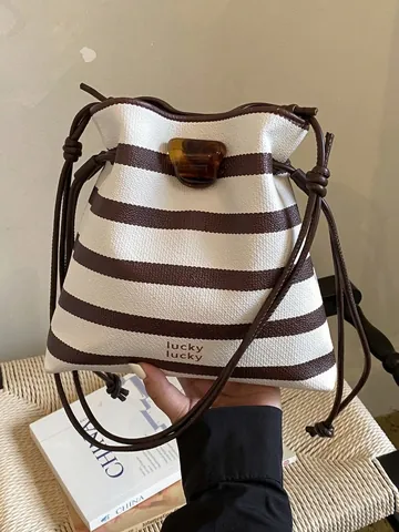 Women Fashion Contrast Striped PU Leather Bucket Bag lucky lucky Print Drawstring Crossbody Bag With Amber Buckle
