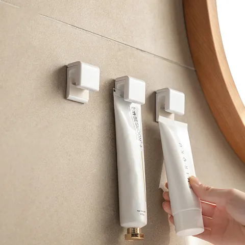 Wall Mounted Punch Free Toothpaste Holder Facial Cleanser Storage Rack Bathroom Adhesive Toothpaste Squeezer Clip Organizer