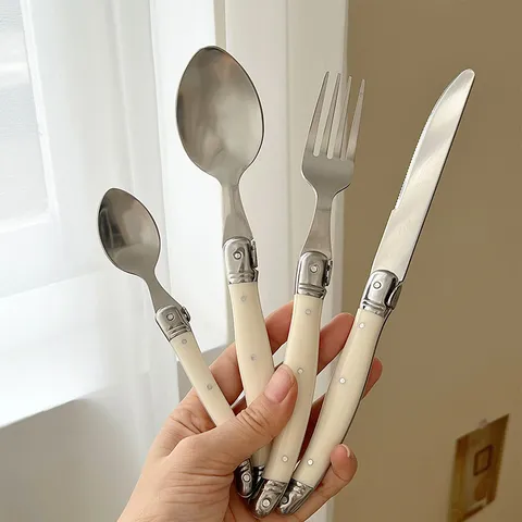 Korean Style Creamy White Curved Handle Stainless Steel Cutlery Set Vintage Laguiole Style Mirror Polished Steak Knife Fork Spoon Set For High Grade Dining Tableware