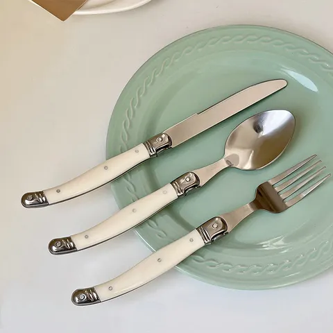 Korean Style Creamy White Curved Handle Stainless Steel Cutlery Set Vintage Laguiole Style Mirror Polished Steak Knife Fork Spoon Set For High Grade Dining Tableware