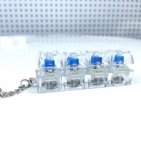Llavero Juguete Antiestrés Teclado Mecánico 4 Teclas Lineal LED Luminoso Colgante Cristal Transparente