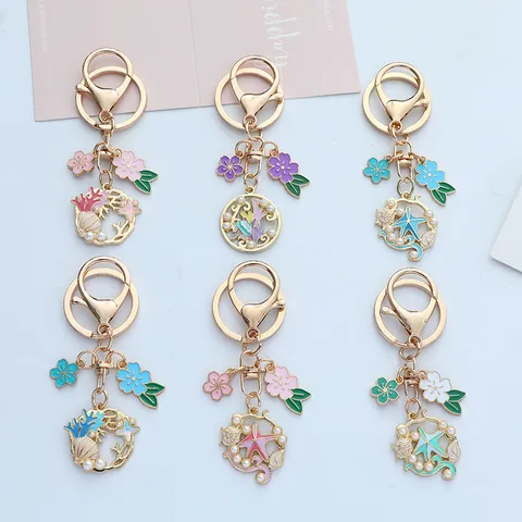 Joli Porte-clés en Alliage de Zinc Style Océan Émail Fleur de Cerisier Étoile de Mer Coquillage Pendentif de Sac Décoration Avec Perle Artificielle