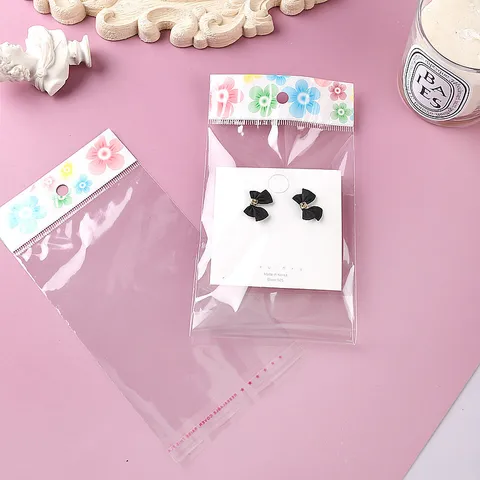 Transparente OPP Selbstklebende Verpackungsbeutel Mit Blumigem Header-Karte Und Aufhängeloch Für Schmuck Kleidung Einzelhandel Lagerung