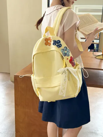 Harajuku-Stil Damen Schulrucksack Kontrastfarbe Blumenstickerei Große Kapazität Nylon Rucksack Mit Spitzenbogen-Anhänger