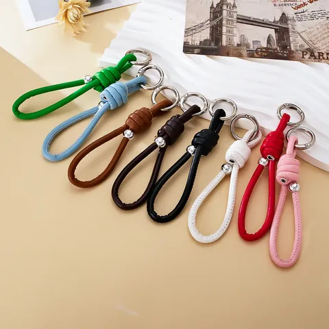 Hand-Woven Leather Rope Keychain Roman Knot Bag Charm Pendant With Metal Bead Minimalist Versatile Car Key Ring Jewelry For Women Men