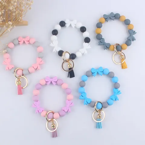 Portachiavi con Perline in Silicone con Fiocco Cartone Animato Bracciale ad Anello in Lega con Nappa Ciondolo Borsa Ornamento Moda per Donne Amici Regalo