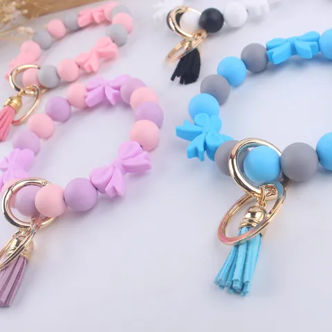 Portachiavi con Perline in Silicone con Fiocco Cartone Animato Bracciale ad Anello in Lega con Nappa Ciondolo Borsa Ornamento Moda per Donne Amici Regalo