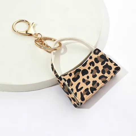 Porte-clés Mini Sac Courbé Imprimé Léopard en Cuir PU Porte-monnaie Mignon Chaîne de Clés Voiture Sac Suspendu Ornement Accessoires
