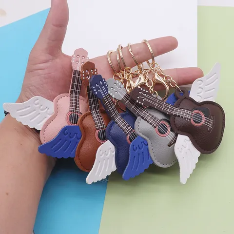 Pendentif en Cuir Créatif Forme Guitare avec Ailes d'Ange Porte-Clés Bijou de Sac pour Fans de Concert Femme Homme Alliage Cuir PU