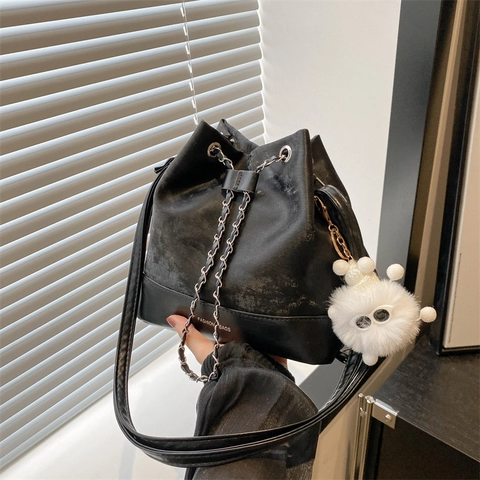 Women PU Leather Bucket Backpack With Metal Chain Drawstring Chic Casual Solid Color Shoulder Bag Plush Doll Pendant