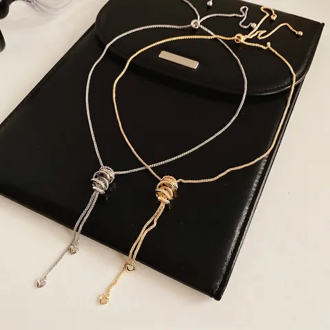 Kupfer Zirkonia Lariat Halskette Verstellbarer Schiebeverschluss Verschlungene Ringe Herzanhänger Luxus Elegant Für Damen