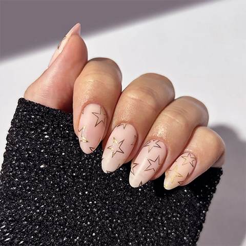 Faux Ongles Press On Amande Rose Clair Avec Motifs Étoiles Dorées Manucure Longue Minimaliste Pour Femmes