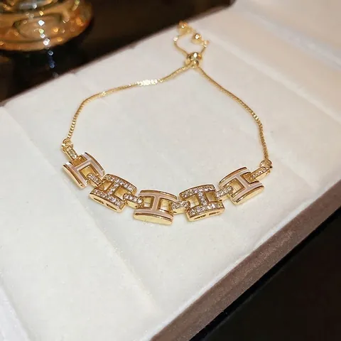 Gold Plated Copper Bracelet With Cubic Zirconia H-Shaped Links And White Enamel Adjustable Slide Clasp For Women Jewelry