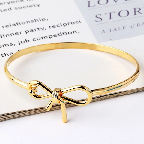 Moda Donna Placcato Oro 18K Rame Bracciale Elegante Minimalista Fiocco Nodo Infinito Design Intrecciato Gioielli Accessorio