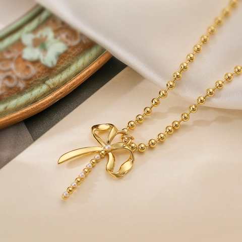 Élégant Collier Pendentif Nœud Papillon en Cuivre Plaqué Or Perle Artificielle Chaîne à Billes Vintage Bijoux Femme
