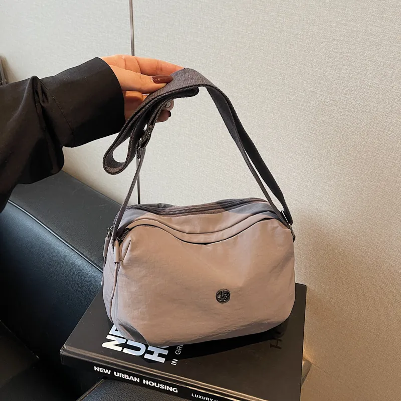 Women Nylon Dumpling Crossbody Bag Trendy Casual Lightweight Shoulder Bag With Adjustable Wide Strap Round Metal Logo