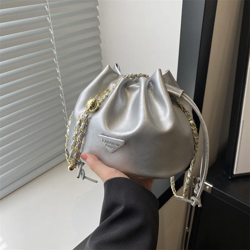 Fashion PU Leather Drawstring Bucket Bag For Women Minimalist Chain Shoulder Crossbody Bag With Triangular Metal Badge