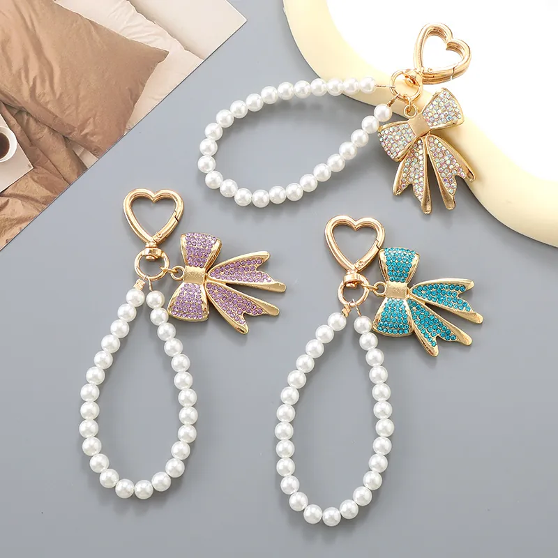 Mode Nœud Papillon en Strass Fausse Künstliche Perle Porte-clés Avec Fermoir Cœur Pendentif de Sac Doux pour Femmes Filles Accessoire de Clé