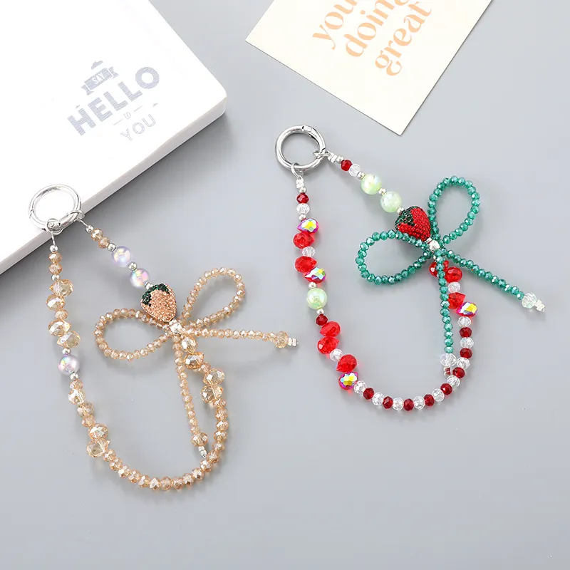 Bijou de Téléphone Perlé Fraise et Nœud Fait Main Strass Alliage Plastique Pendentif de Sac Dragonne Accessoire Femme Filles