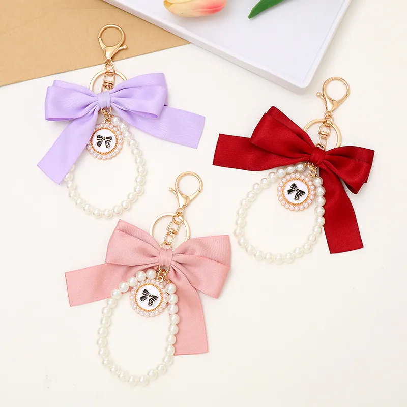 Porte-clés Élégant à Nœud Papillon en Satin et Künstliche Perles Pendentif de Sac Ruban Nœud Fausse Künstliche Perle Pour Femmes Accessoire de Mode