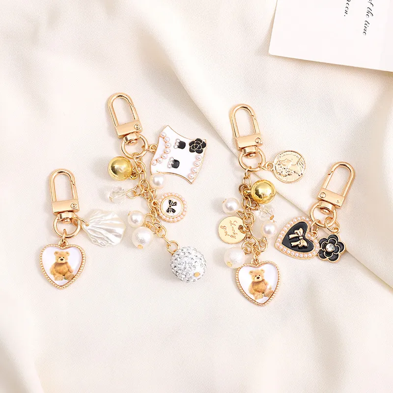Élégant Porte-clés Nœud en Künstliche Perles Alliage Doré Camélia Ours en Peluche Cœur Pendentif Bijou de Sac Femme Accessoire Mode Luxe