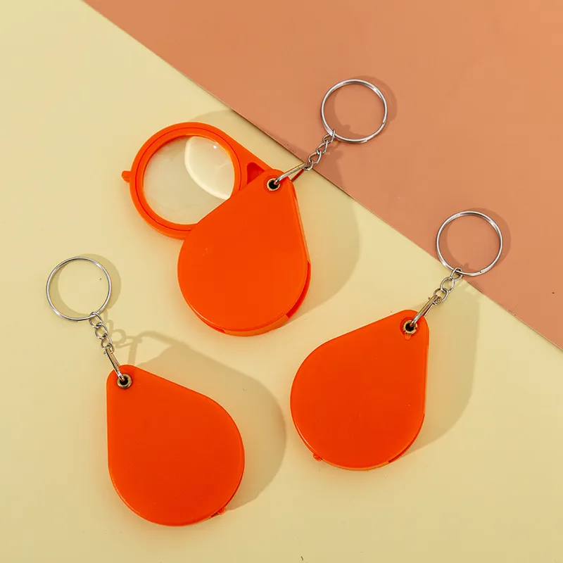 Llavero Lupa Plegable Portátil Mini Lupa de Bolsillo Anillo Clave Metal Plástico Herramienta de Lectura Regalo
