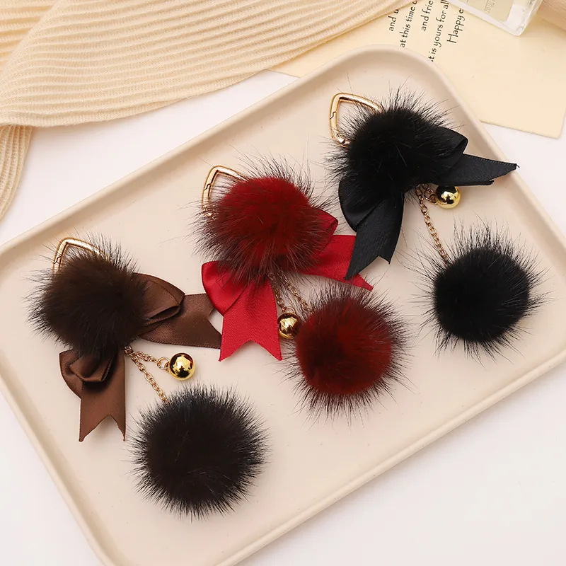 Portachiavi con Pompon in Peluche alla Moda Fiocco in Nastro Campanello Dorato Ciondolo per Borsa Donna Decorazione per Zaino e Borsetta